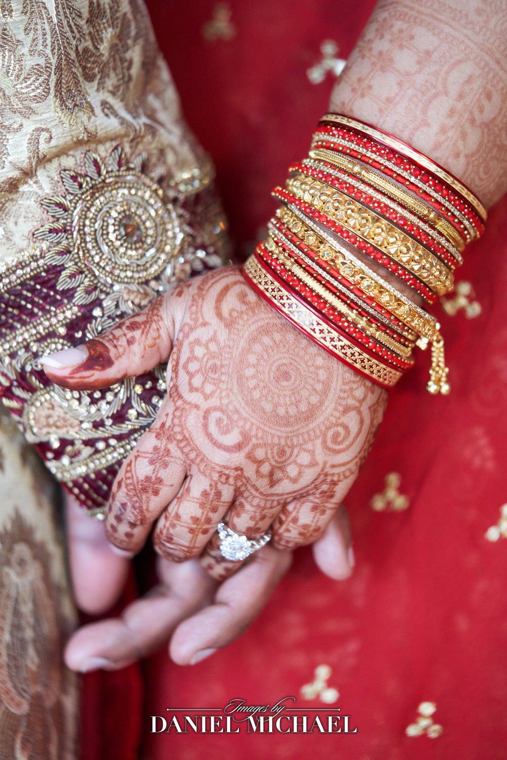 Indian wedding couple holding hands featuring henna